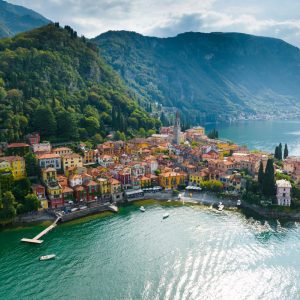 Flying,Over,Colorful,Houses,Of,Varenna,Village,On,Lake,Como,