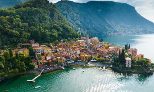 Flying,Over,Colorful,Houses,Of,Varenna,Village,On,Lake,Como,